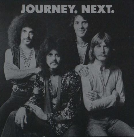 A black-and-white 1977 trade advertisement headed JOURNEY. NEXT. showing four men, the band before Steve Perry joined: two with long dark hair and moustaches, one with a full beard, one with shorter curly hair, all looking at the camera